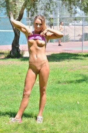 Fit blonde jogger in short shorts revealing wide open twat in public park on fanspics.net