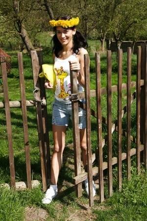 Sweet brunette teen Amanda undressing her clothes outdoors on fanspics.net