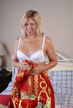 Older blonde lady removes hot white lingerie set for cunt masturbation on fanspics.net