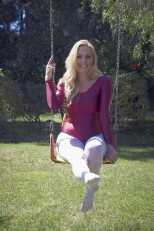 Busty blonde Hayley Marie Coppin strips bodysuit and white pantyhose outdoors on fanspics.net