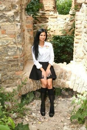 Horny teen removes her school uniform to masturbate in a secluded spot outside on fanspics.net