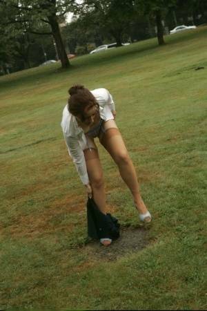 Amateur chick Dirty Angie strips to her pretties and tan nylons in a park on fanspics.net