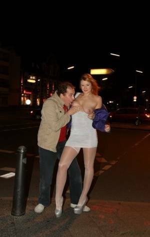 Slutty LaMia in white stockings topless sucks on her knees in the street on fanspics.net