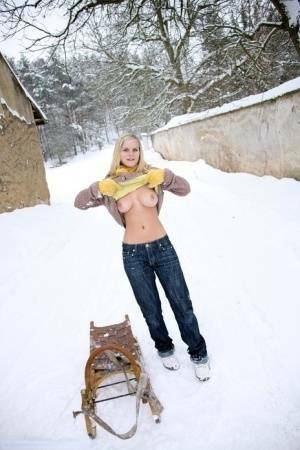 Busty blonde bares big tits in the snow & sucks POV for mouthful of cum on fanspics.net