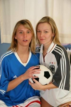 Cute teen girls go lesbian after trying on soccer outfits on a bed on fanspics.net