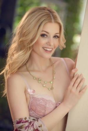 Beautiful blonde Charlotte Stokely uncovers tiny tits before petting her pussy on fanspics.net