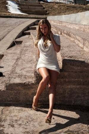 Hot blonde in white dress flashes pierced tits & naked pussy upskirt outdoors on fanspics.net