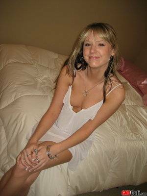 Cute teen Cali strips out of her little white nighty on fanspics.net