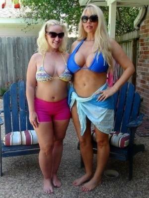 Blonde chicks Karen Fisher and Dee Siren loose their big tits from bikini tops on fanspics.net