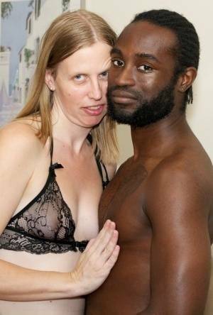 White amateur deepthroats her black lover's cock in lingerie ensemble on fanspics.net