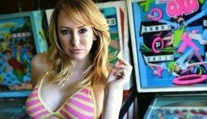 Brett Rossi fingers her pussy in striped OTK socks atop pinball machine on fanspics.net