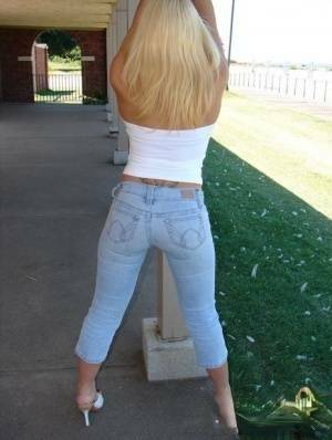 Blonde amateur Karen exposes her lace thong while outdoors in faded jeans on fanspics.net