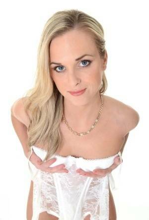 Pretty blonde Vinna Reed takes off white lingerie and matching hosiery on fanspics.net