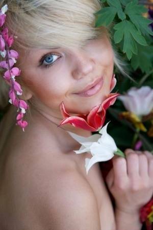 Cute young blonde Iveta poses in the nude while in a garden on fanspics.net