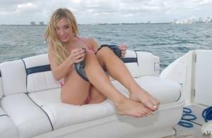 Lusty blonde Amy Brooke strips bikini and rubs pussy on the boat on fanspics.net