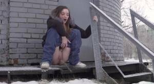 White girl pulls down her jeans to pee in the snow behind a building on fanspics.net