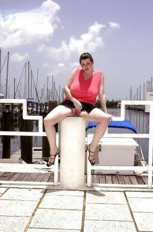 Plump pornstar Desirae flashing her huge tits and upskirt pussy on boat dock on fanspics.net