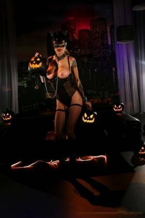 Tattooed chick Sarah Jessie exposes her tits and twat in a Catwoman mask on fanspics.net