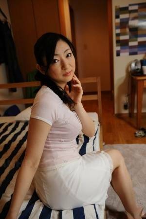 Slender mature Japanese woman Emiko Koike bends over to pose in white dress - Japan on fanspics.net