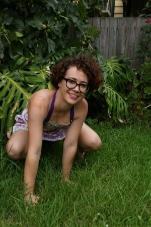 Geeky girl Rosie wears her glasses for her nude debut on the back lawn on fanspics.net
