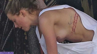 Amber Heard caught topless on the beach on fanspics.net