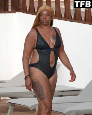 Sandi Bogle Shows Off Her Voluptuous Figure in a Swimsuit Poolside Out in Ibiza on fanspics.net