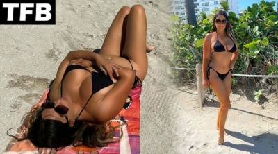 Claudia Romani Shows Off Her Curves on the Beach on fanspics.net