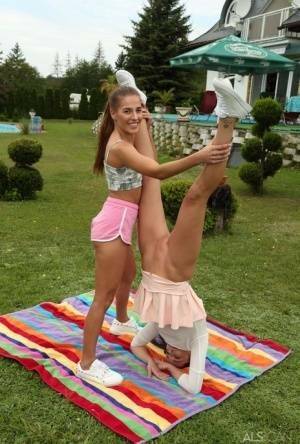 Young lesbians Eveline Dellai & Katy Rose fist pussies during sex on a lawn on fanspics.net