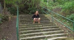 Natural redhead Chrissy Fox squats for a pee on a set of public steps on fanspics.net