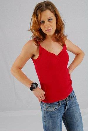 Natural redhead Sabine shows off her black G-shock watch while fully clothed on fanspics.net