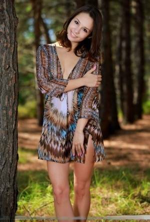 Sweet teen with an ass to die for disrobes for great nude poses in a forest on fanspics.net