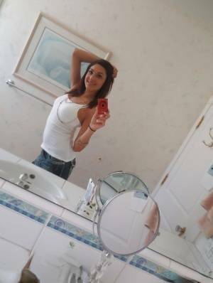 Nasty brunette slut Nikka taking couple of selfies in the bathroom on fanspics.net