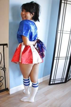 Tiny Asian cheerleader May Lee posing in cute uniform and socks on fanspics.net