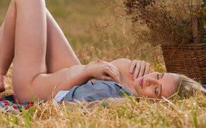 Blonde teen Penelope G displays her great body in a freshly cut farmer's field on fanspics.net