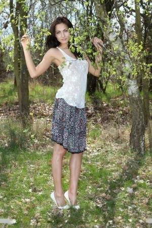 Long legged Michaela Isizzu flashes naked upskirt and poses nude in the forest on fanspics.net