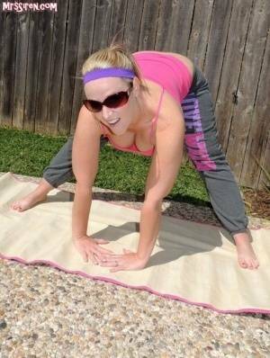 Blonde chick Dee Siren frees her huge ass from yoga pants outdoors on yoga mat on fanspics.net