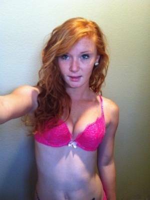 Natural redhead Alex Tanner slips off her pink lingerie set for nude selfies on fanspics.net