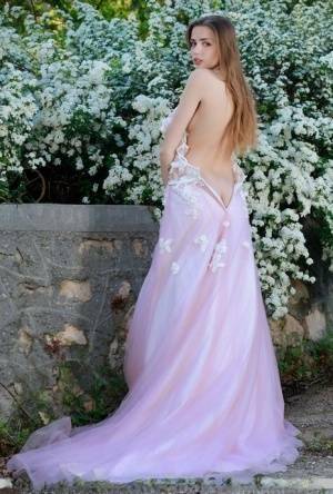 Beautiful girl Elle Tan slips off wedding dress to pose nude in garden on fanspics.net