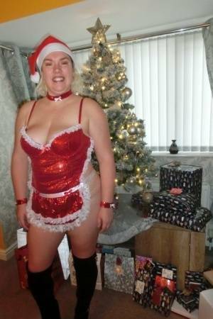 Busty blonde Barby masturbates her shaved pussy near the Christmas tree on fanspics.net