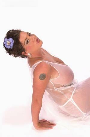 Buxom Linsey Dawn poses to flaunt her droopy tatas in sheer lingerie on fanspics.net