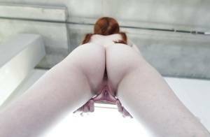 Young redhead Dolly Little revealing shaved pussy in pigtails and socks on fanspics.net