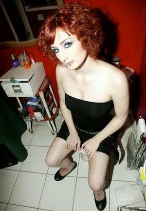 Pale redhead Violet Monroe gets naked in flat shoes while in a bathroom on fanspics.net