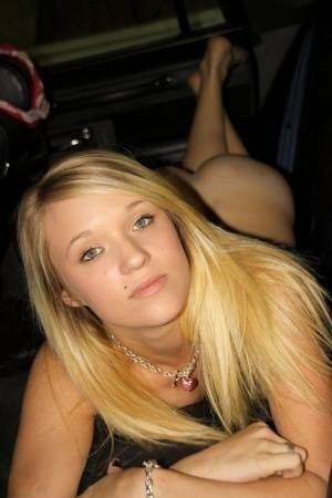 Blonde amateur Teagan slides lace panties aside to get naked inside a vehicle on fanspics.net