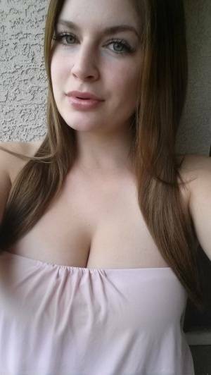 Plump amateur Danielle takes topless and clothed selfies around the house on fanspics.net