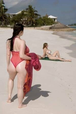 Plump female Christy Mark and her big boobed friend have lesbian sex on beach on fanspics.net