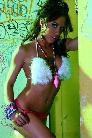 Hot MILF Capri Cavanni peels off her bikini amid graffiti in furry boots on fanspics.net