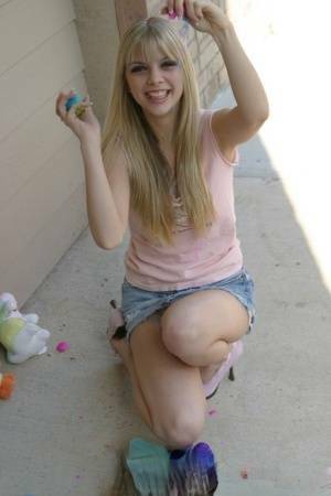 Sweet blonde teen Jana Jordan flashes upskirt panties while eating chocolate - Jordan on fanspics.net