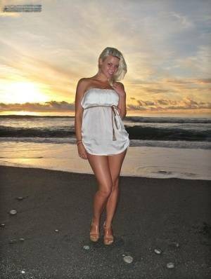 Hot blonde Anikka Albrite strips naked at the beach before nude hitchhiking on fanspics.net