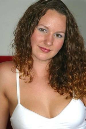 Amateur chick with wavy hair and a phat ass finger spreads her pussy on a sofa on fanspics.net