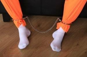 Female prisoner is left alone while cuffed in an orange jumper and white socks on fanspics.net